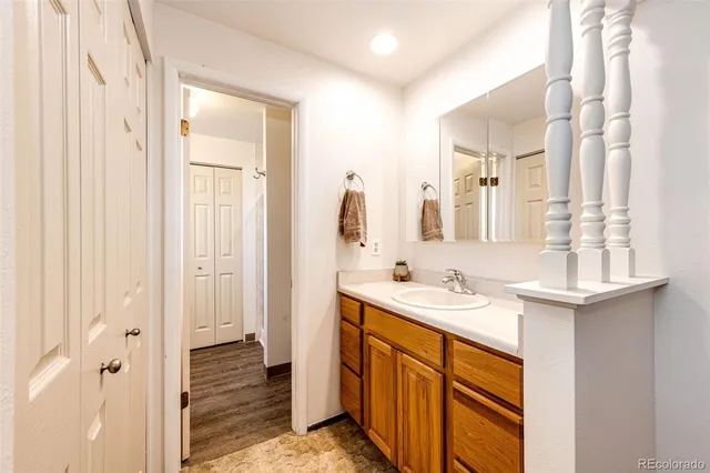 a bathroom with a granite countertop shower mirror and a sink