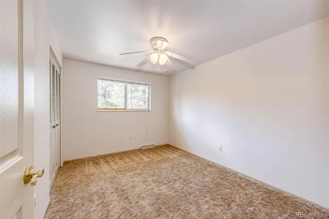 a view of a room with wooden floor and a bathroom