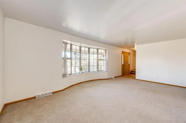 a large kitchen with stainless steel appliances granite countertop a stove a sink and a refrigerator