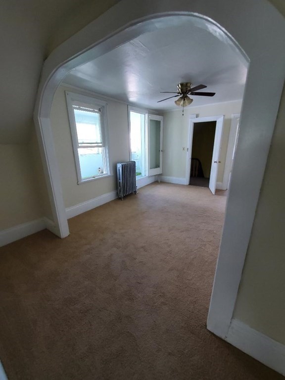 163 New Boston Road, Unit 2 Fall River, MA 02720 - Photo 1 of 15 an empty room with windows and fireplace