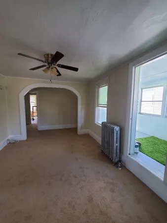 a view of a livingroom with a ceiling fan and window