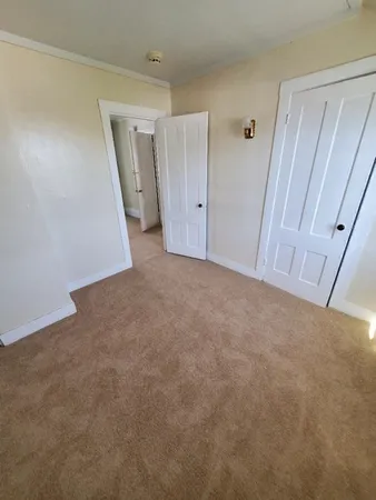 a bedroom with window and gate