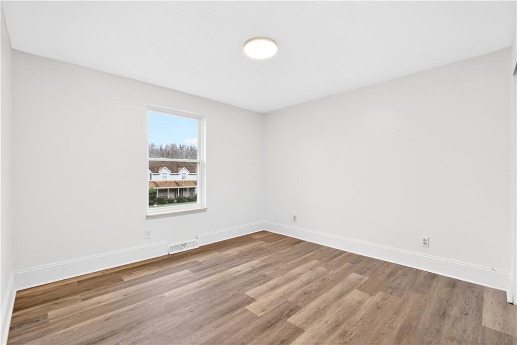 3 Park Road Charleroi, PA 15022 - Photo 20 of 43 an empty room with wooden floor and windows