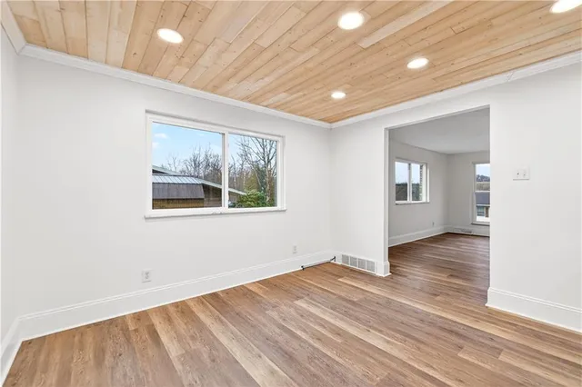 a kitchen with kitchen island granite countertop a sink stainless steel appliances and cabinets