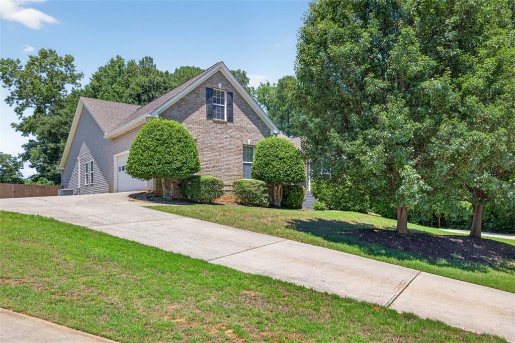 89 Katie Spring Lane Jefferson, GA 30549 - Photo 63 of 63 a view of a house with yard and a garden