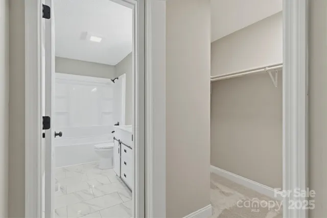 a bathroom with a shower and a glass door