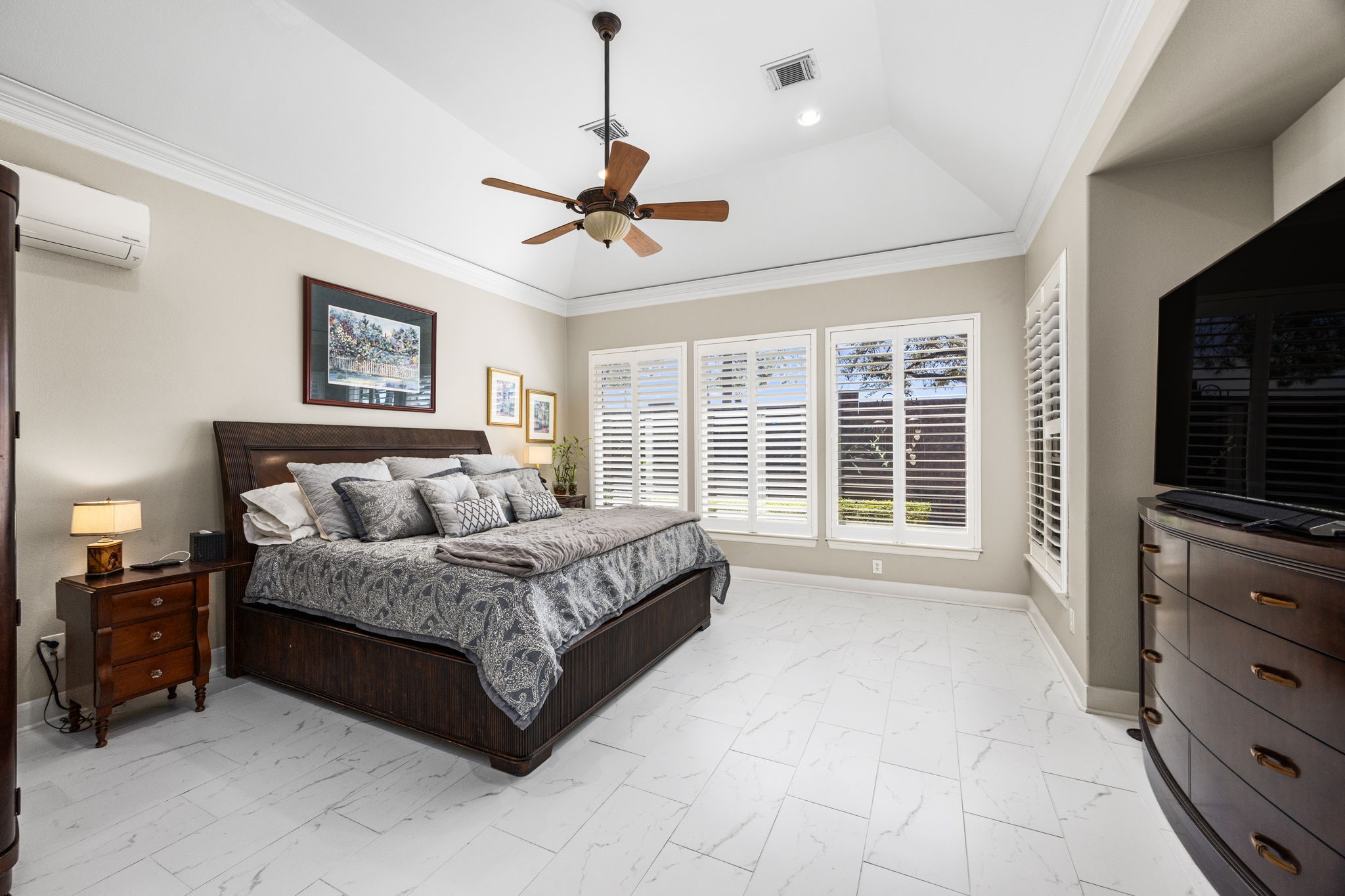 11413 Gallant Ridge Lane Houston, TX 77082 - Photo 23 of 48 a spacious bedroom with a large bed and a flat tv screen on dresser