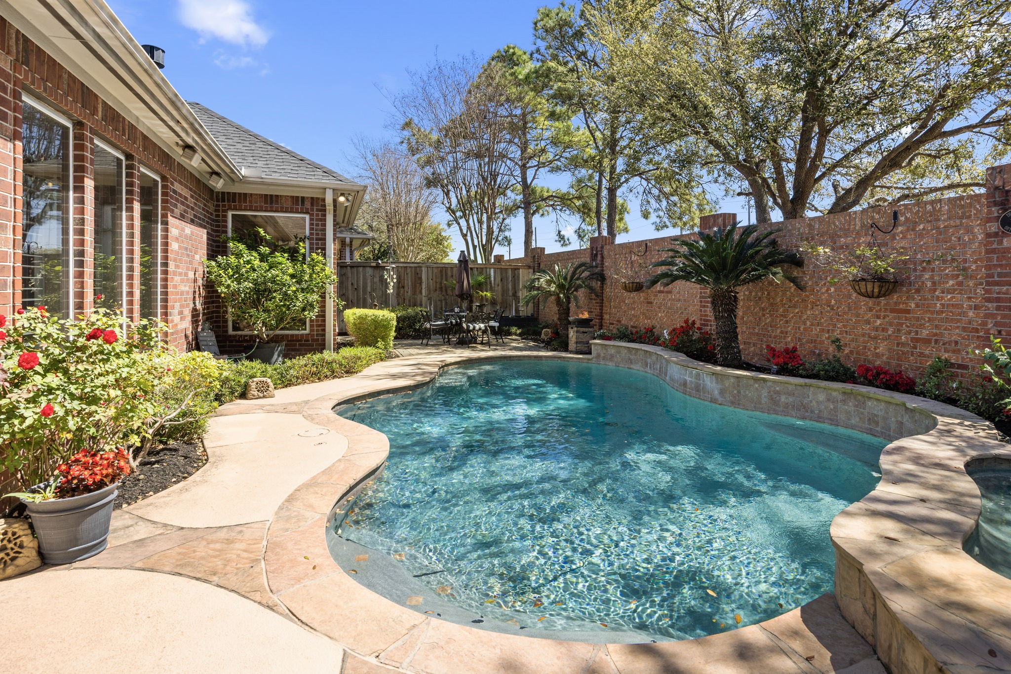 11413 Gallant Ridge Lane Houston, TX 77082 - Photo 43 of 48 a view of a backyard with potted plants and a fountain