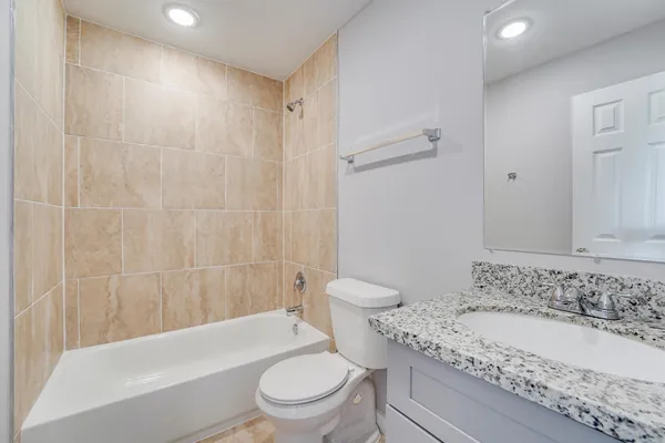 a bathroom with a sink a toilet and a bathtub