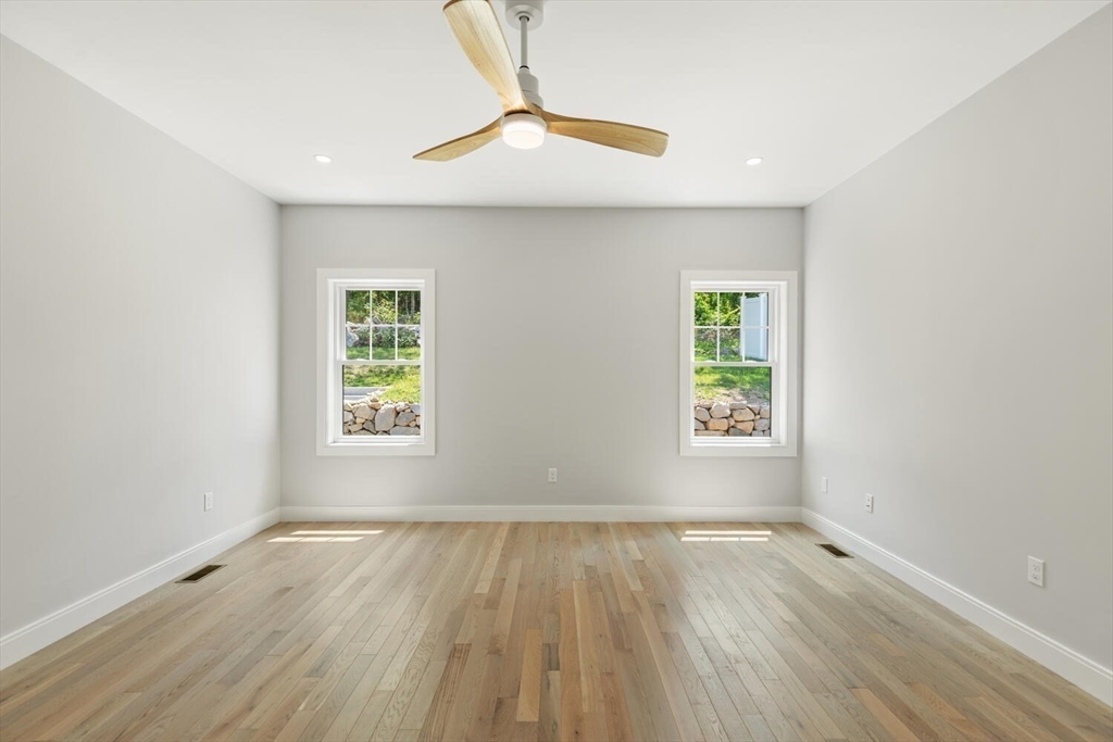 28 Riverview Road, Unit A Gloucester, MA 01930 - Photo 16 of 36 an empty room with wooden floor and windows