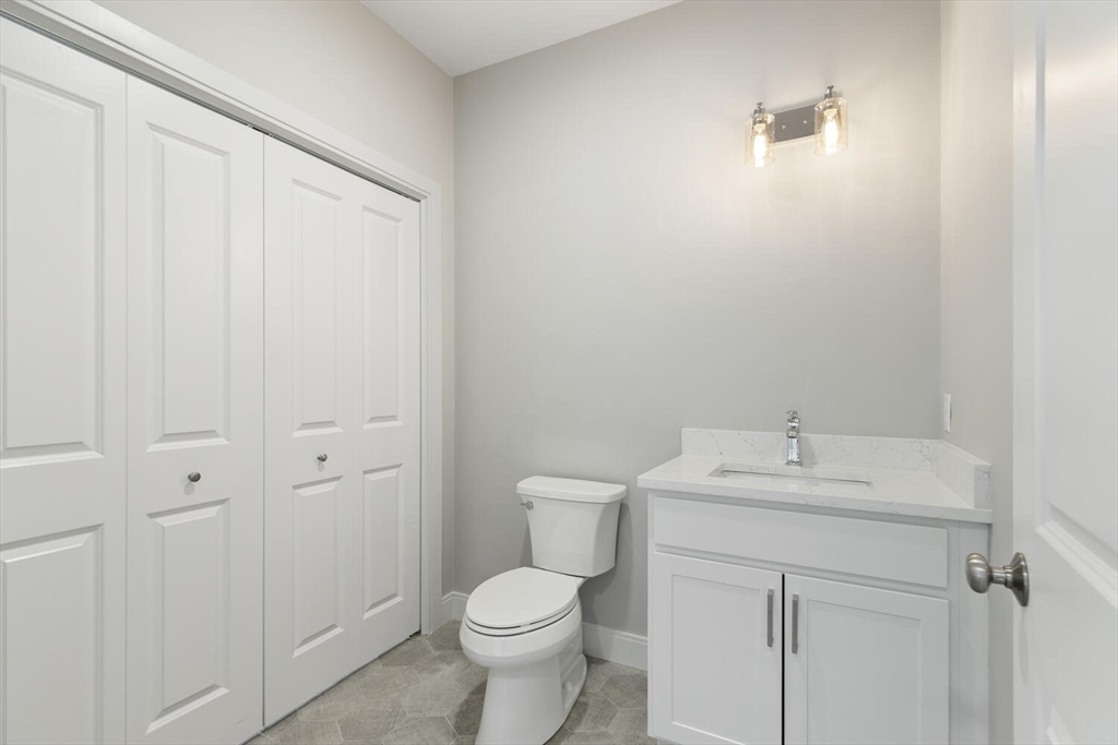 28 Riverview Road, Unit A Gloucester, MA 01930 - Photo 21 of 36 a bathroom with a sink a toilet and a mirror
