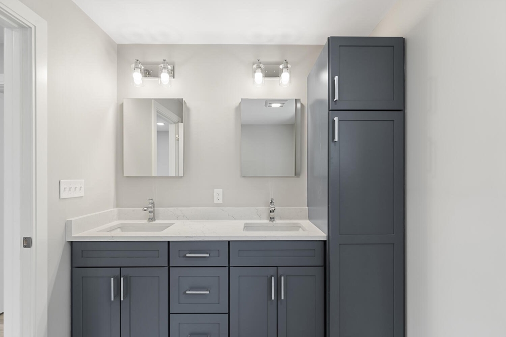 28 Riverview Road, Unit A Gloucester, MA 01930 - Photo 25 of 36 a bathroom with a double vanity sink and mirror