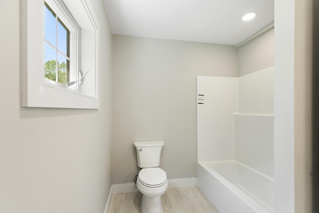 28 Riverview Road, Unit A Gloucester, MA 01930 - Photo 27 of 36 a white toilet sitting next to a bath tub