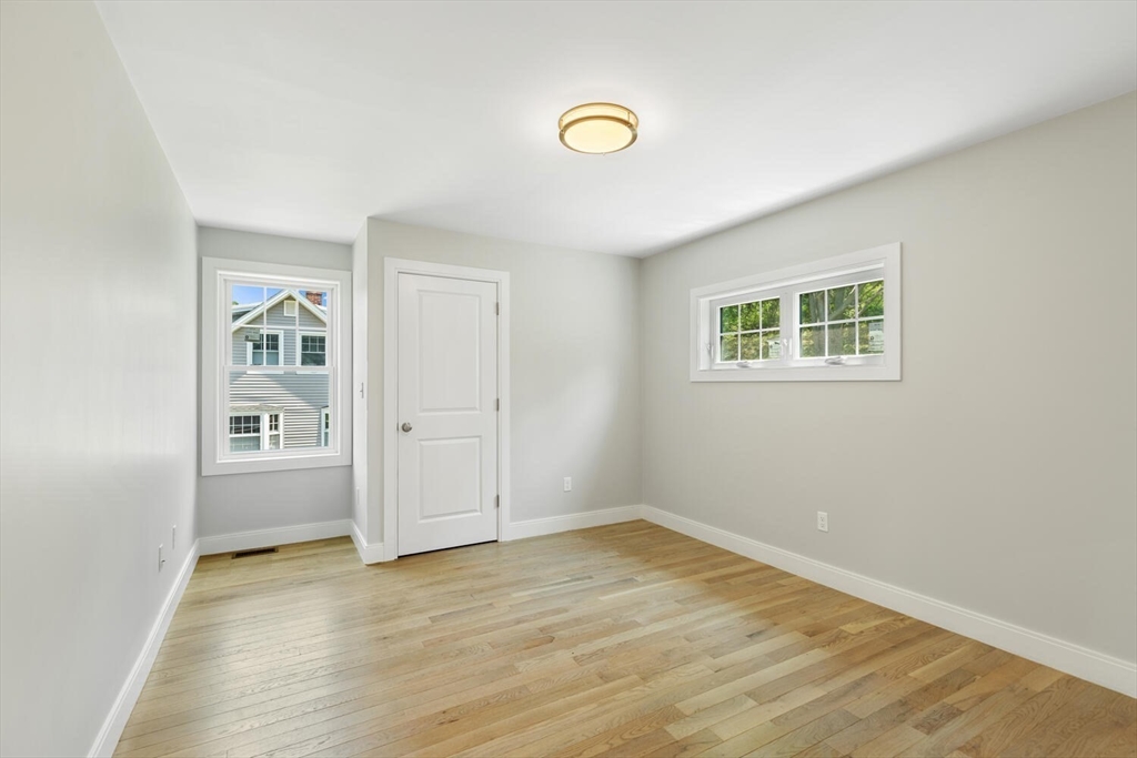 28 Riverview Road, Unit A Gloucester, MA 01930 - Photo 28 of 36 a view of empty room with wooden floor and fan