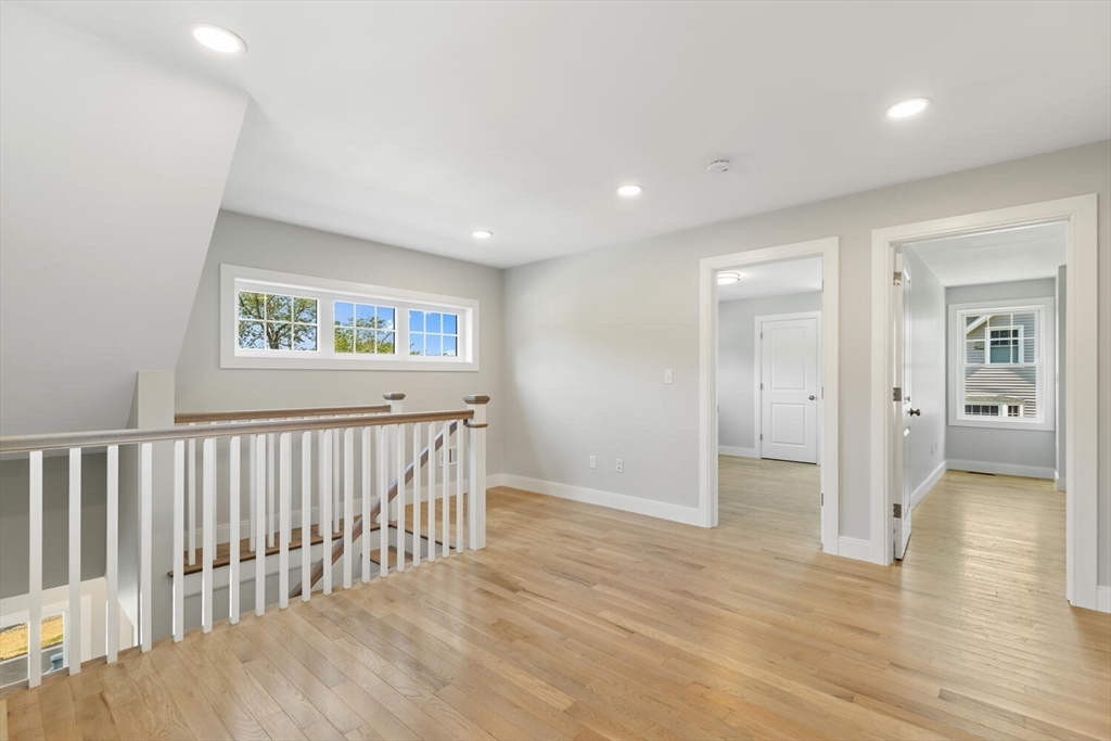 28 Riverview Road, Unit A Gloucester, MA 01930 - Photo 31 of 36 a view of a hallway with wooden floor and windows