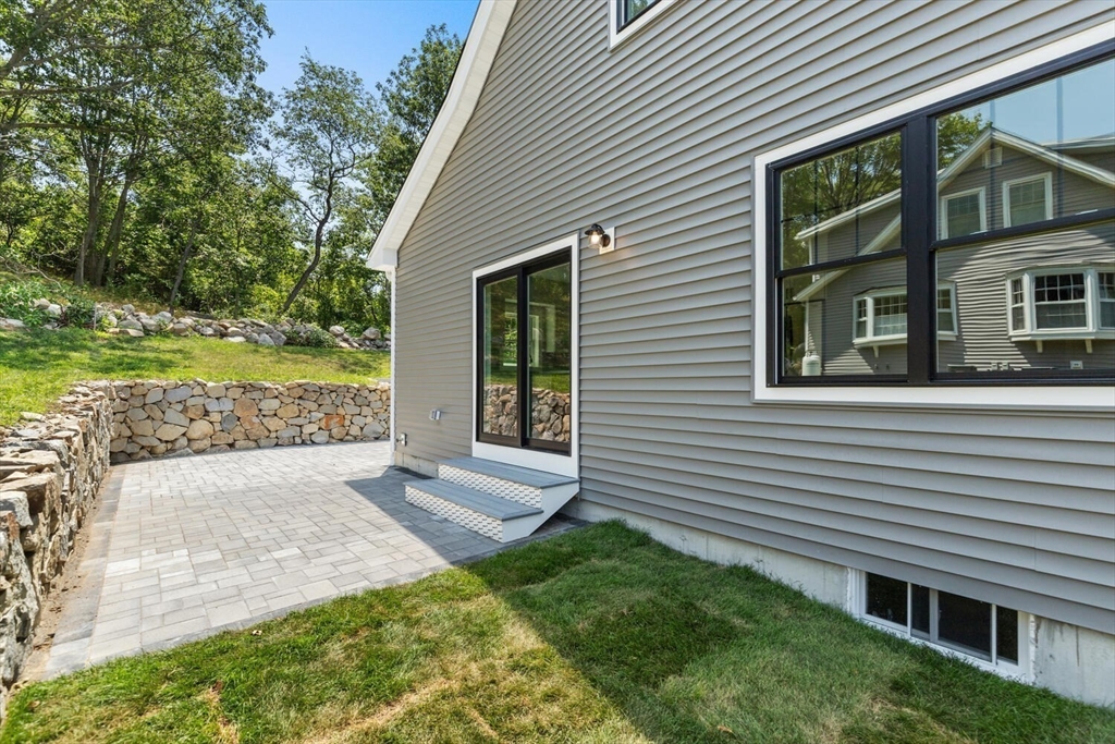 28 Riverview Road, Unit A Gloucester, MA 01930 - Photo 32 of 36 a view of a house with a yard and potted plants