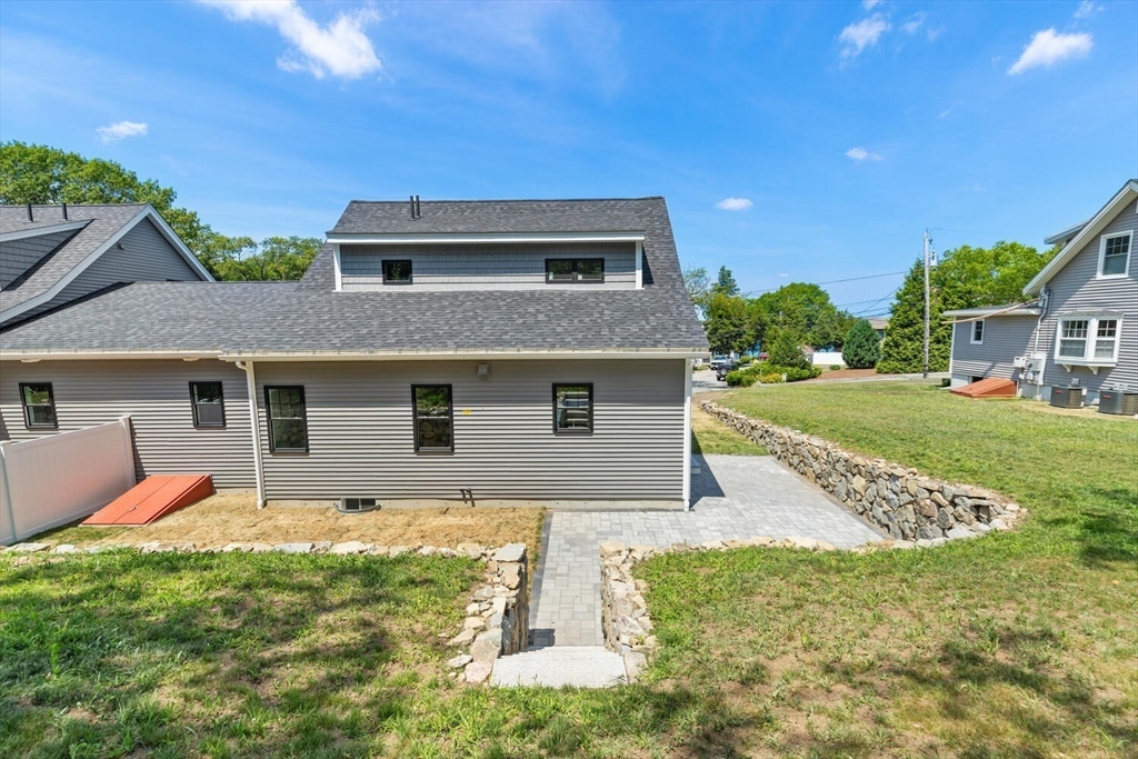 28 Riverview Road, Unit A Gloucester, MA 01930 - Photo 34 of 36 a front view of house with yard and trees in the background