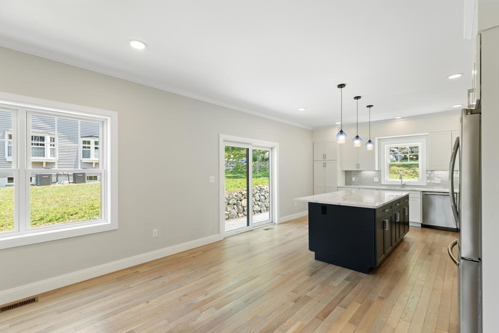 28 Riverview Road, Unit A Gloucester, MA 01930 - Photo 10 of 36 a kitchen with stainless steel appliances granite countertop a stove a sink and a large window