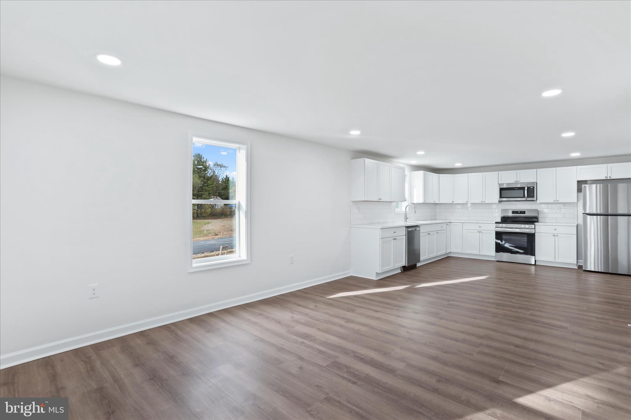 485 Bedington Road Martinsburg, WV 25404 - Photo 3 of 37 a view of empty room with wooden floor and kitchen