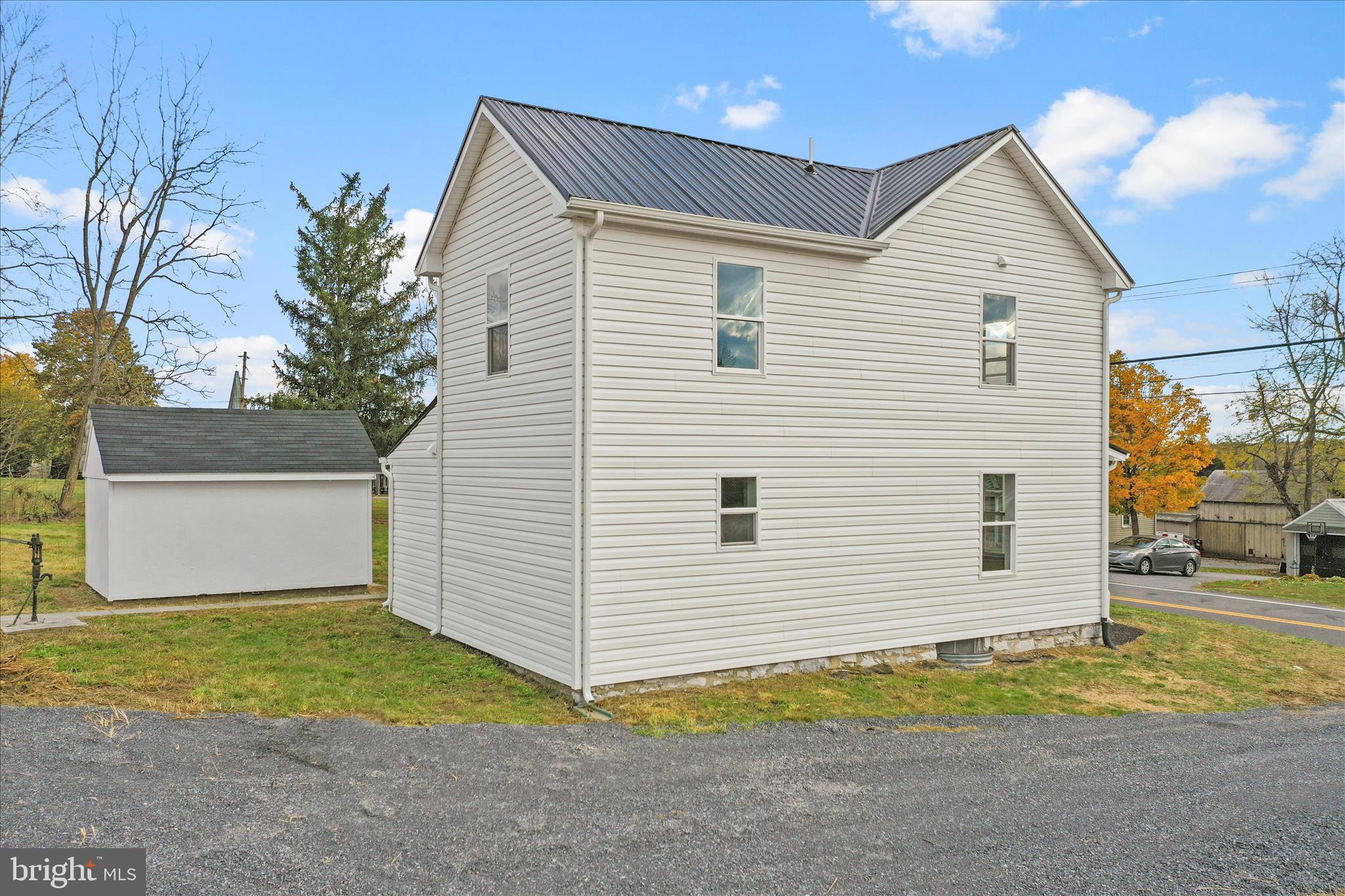 485 Bedington Road Martinsburg, WV 25404 - Photo 35 of 37 a view of a white house next to a yard and road