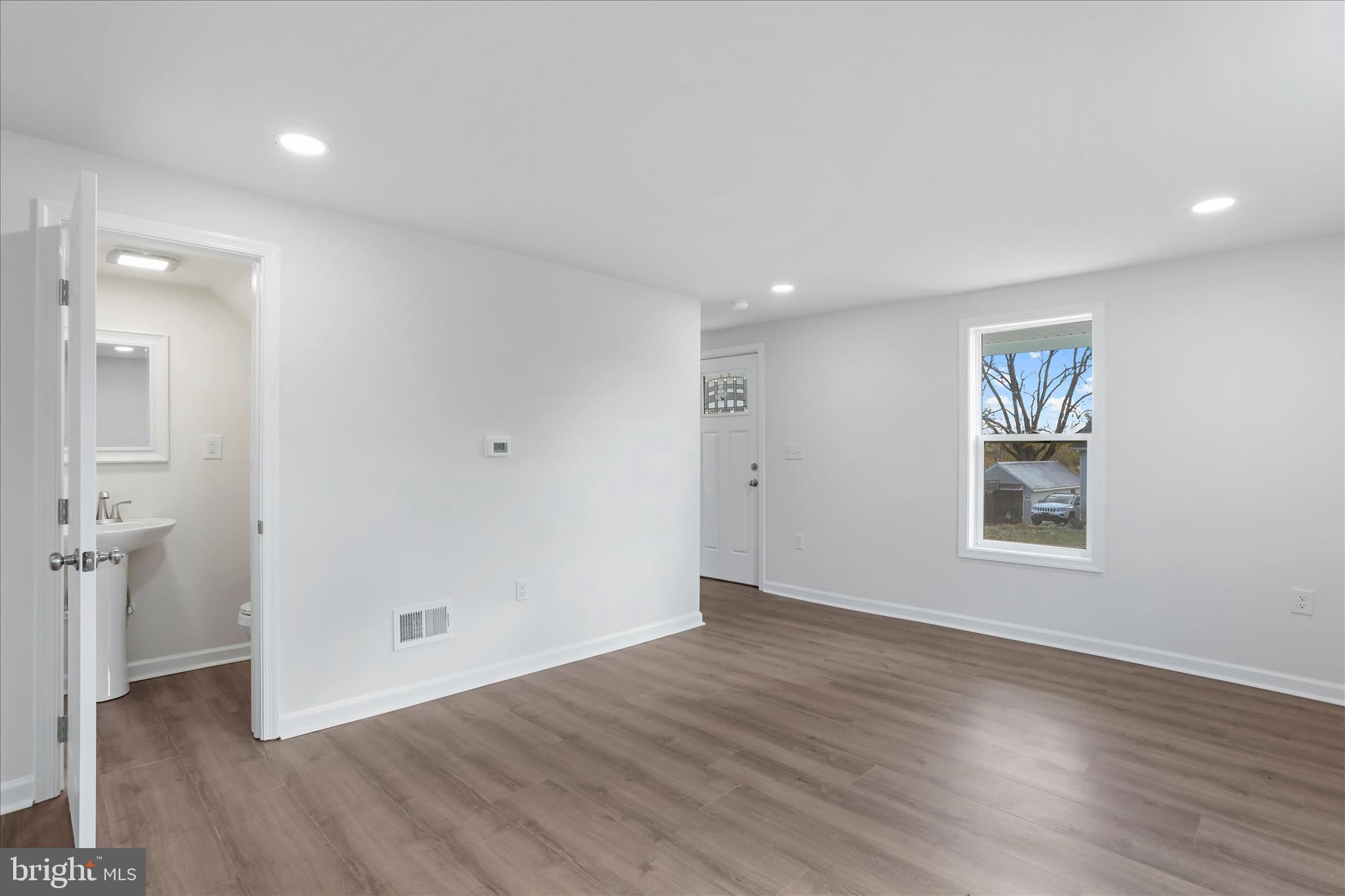 485 Bedington Road Martinsburg, WV 25404 - Photo 6 of 37 an empty room with wooden floor and windows