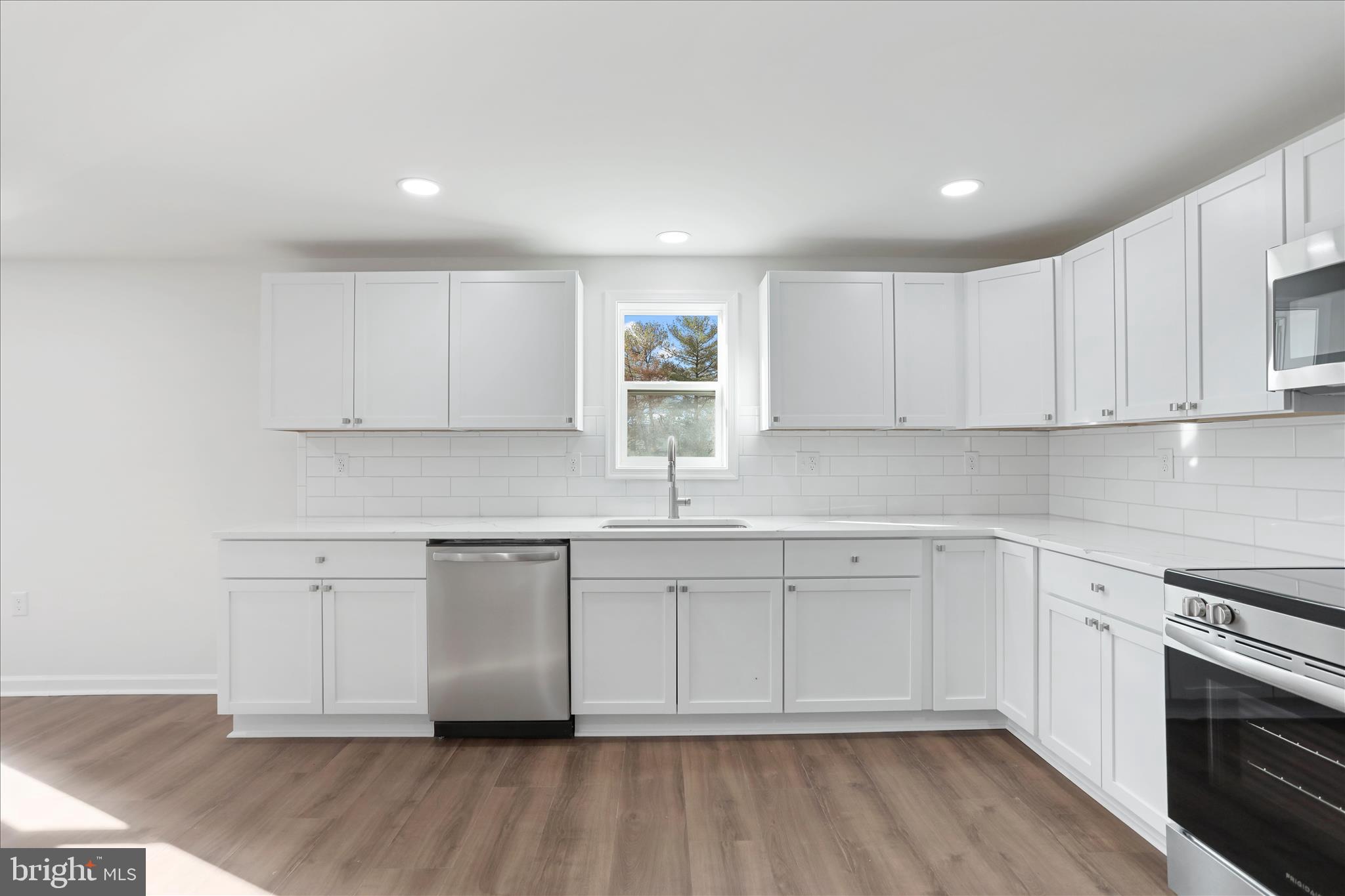 485 Bedington Road Martinsburg, WV 25404 - Photo 9 of 37 a kitchen with granite countertop white cabinets and white appliances
