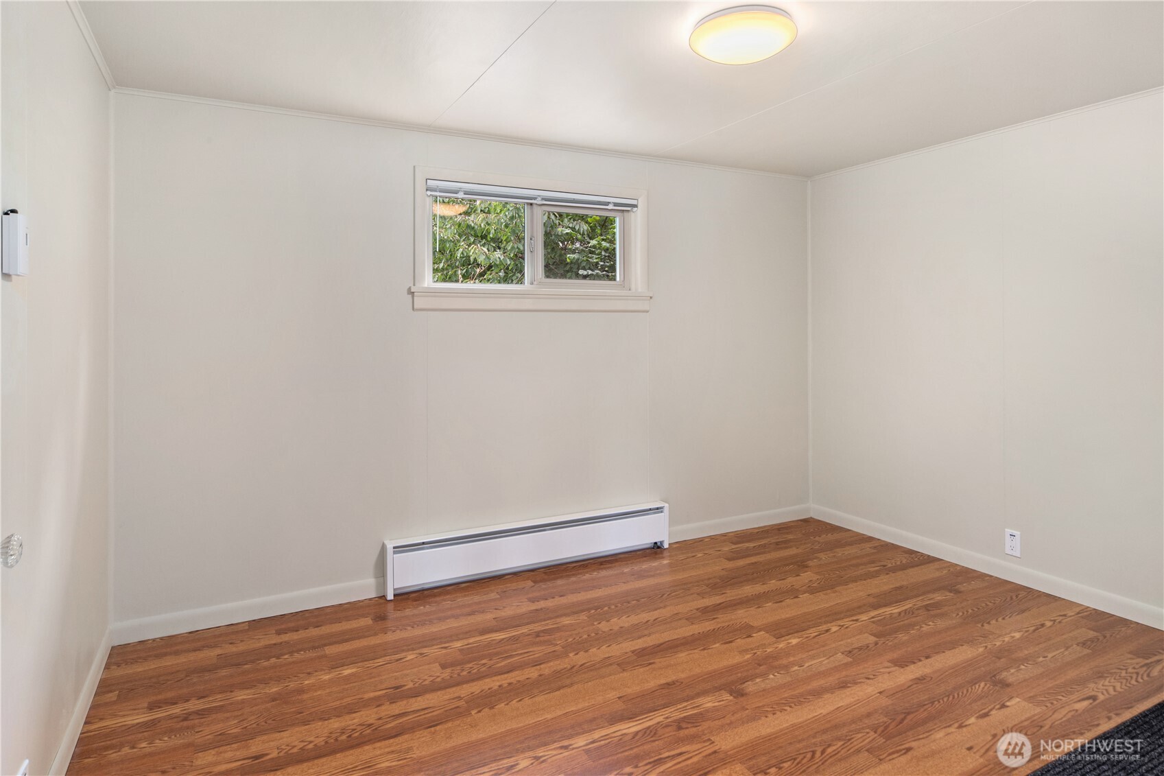 301 E Street Port Townsend, WA 98368 - Photo 11 of 19 an empty room with wooden floor and windows