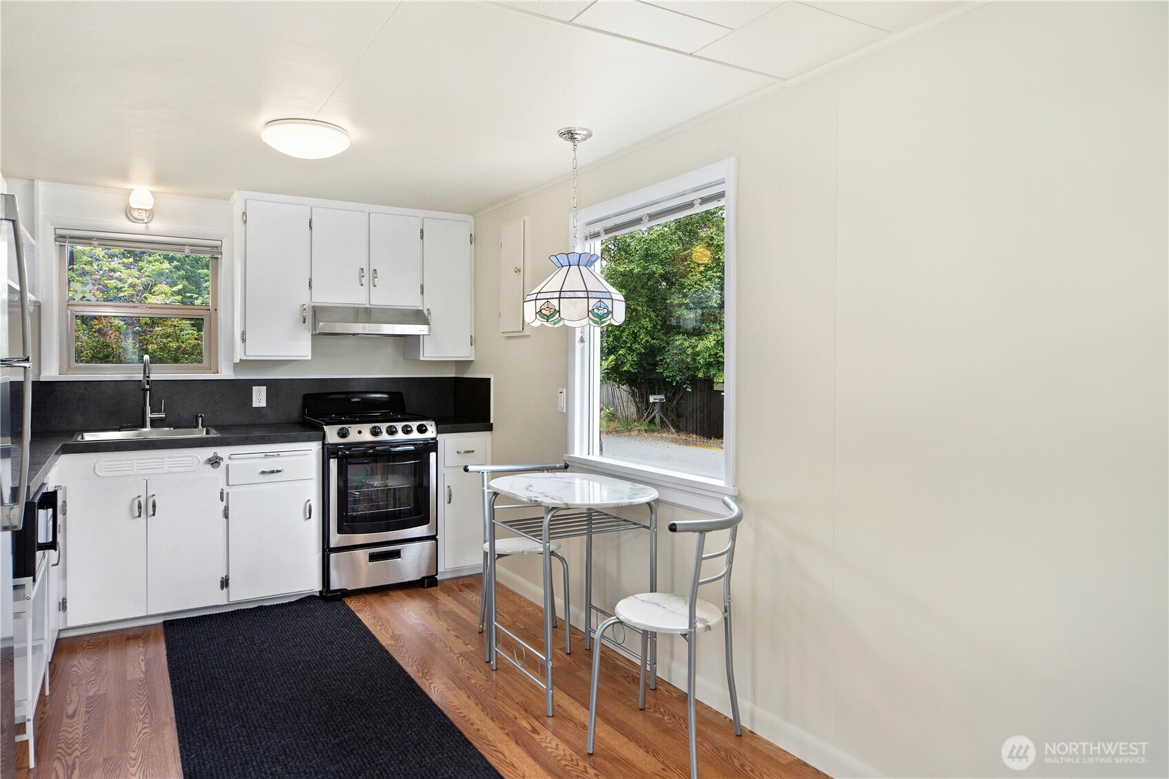 301 E Street Port Townsend, WA 98368 - Photo 7 of 19 a kitchen with a stove a sink and a window