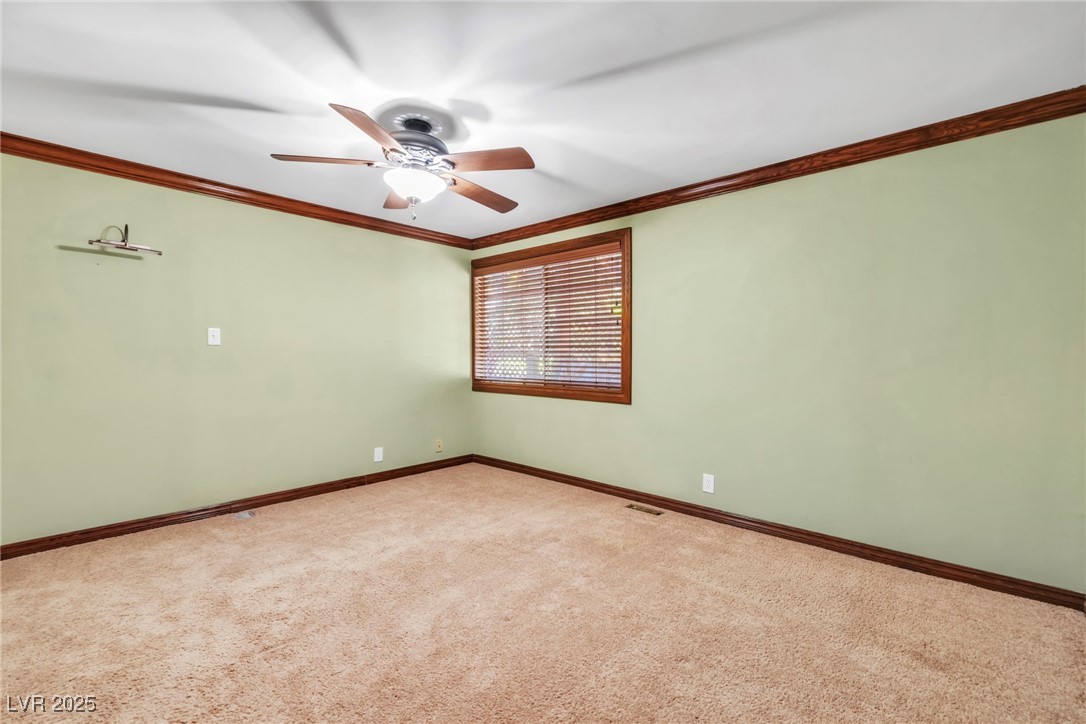 4063 Zugspitz Way Mount Charleston, NV 89124 - Photo 62 of 89 Carpeted spare room featuring ornamental molding and a ceiling fan