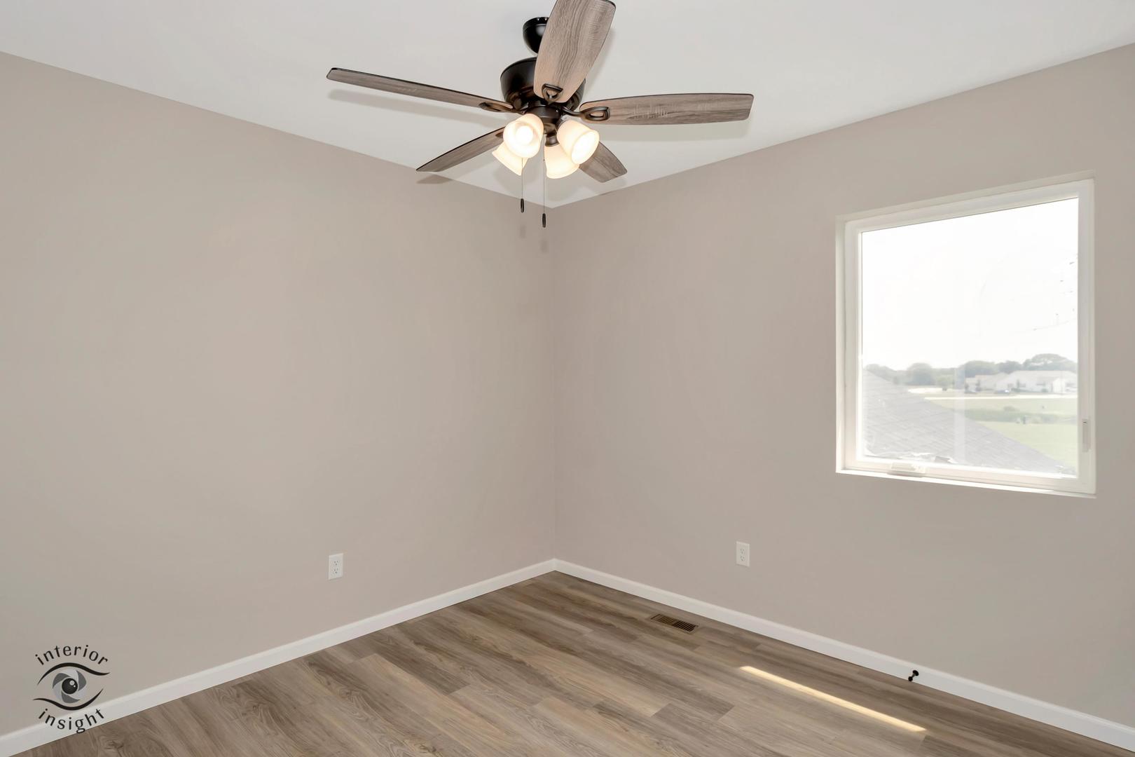 1317 Sioux Turn Kankakee, IL 60901 - Photo 28 of 35 an empty room with a window and a fan