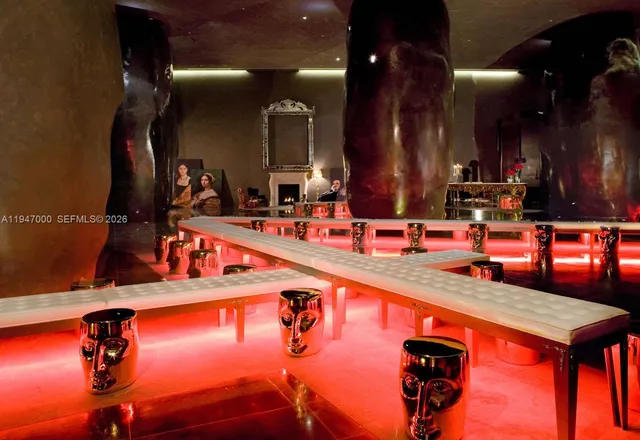 a view of an outside dining space with a table and chairs