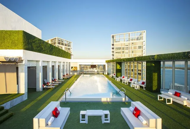 a view of swimming pool with outdoor seating and city view