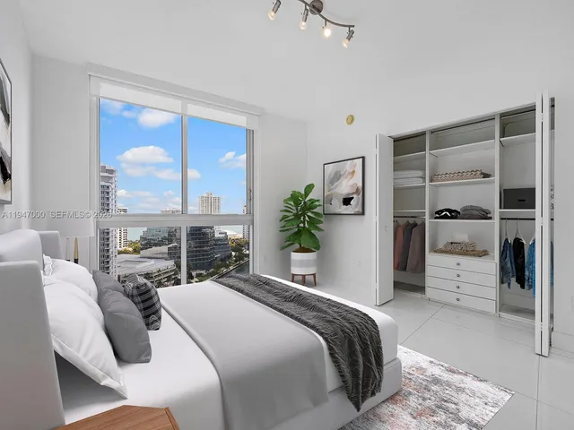 a bedroom with a large bed and a large window