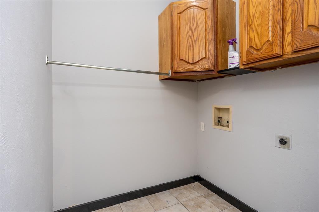 1206 Oakbluff Drive Lancaster, TX 75146 - Photo 11 of 23 Utility Room has cabinets and tile floors.