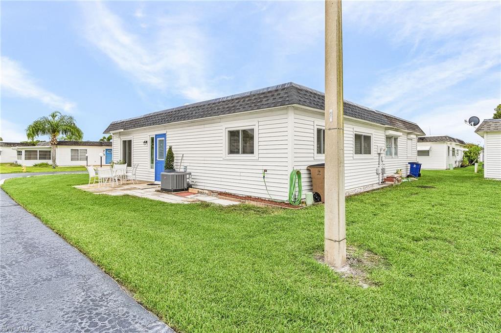 34 Hamlin Court Lehigh Acres, FL 33936 - Photo 5 of 29 a front view of house with yard and green space