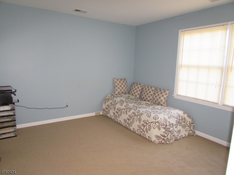 8 Genoble Road Montville, NJ 07045 - Photo 10 of 12 a living room with a bed and a window