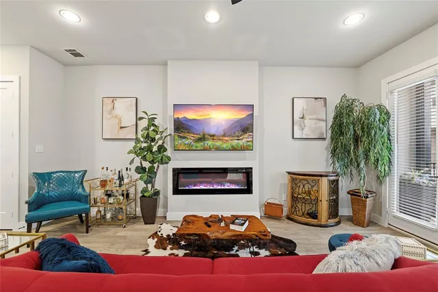 a living room with furniture fireplace and a potted plant