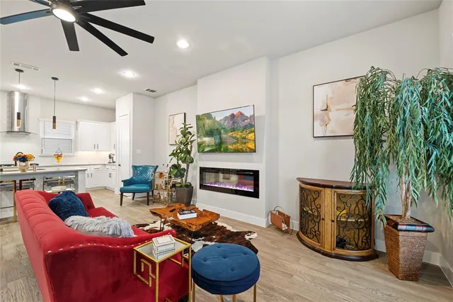 a living room with furniture and a potted plant