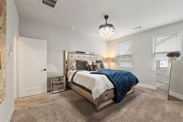 a spacious bedroom with a bed and a large window