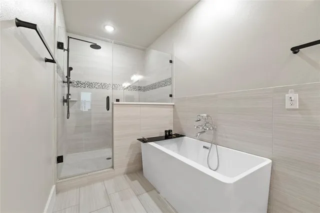 a bathroom with a bathtub and shower