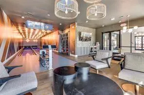 a living room with furniture and floor to ceiling windows