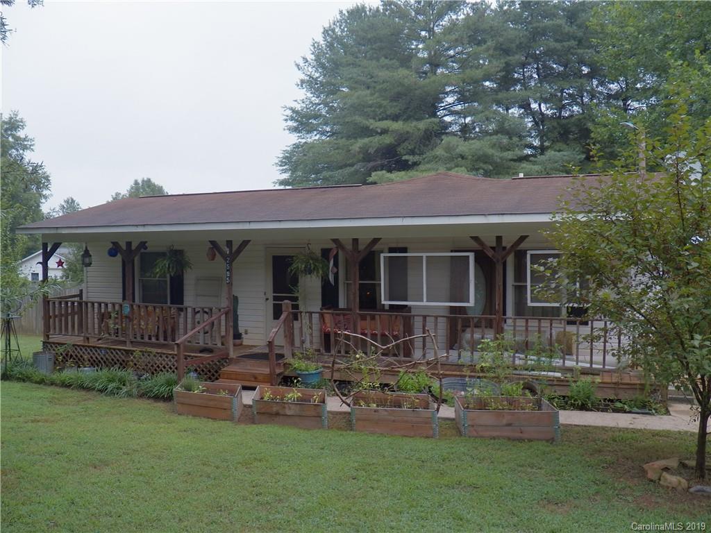 a front view of a house with a garden and porch