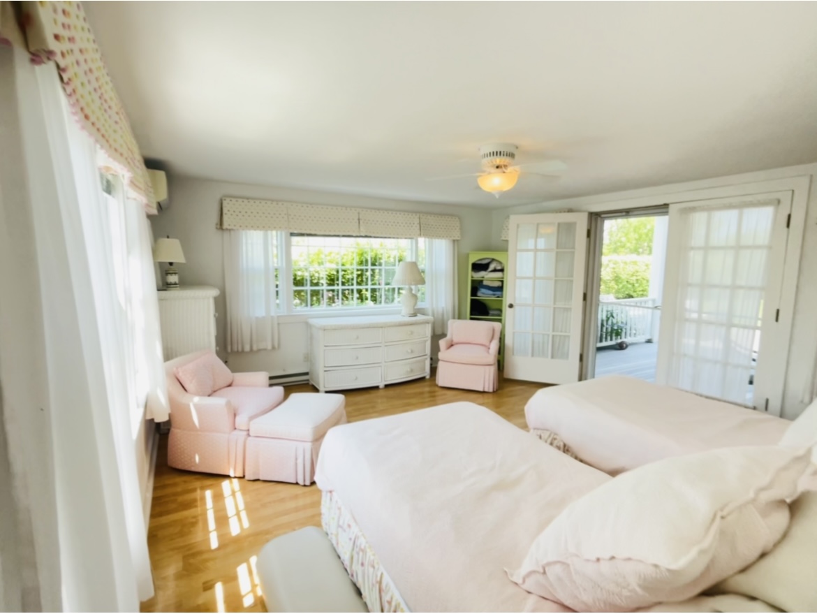 76 Baxter Road Nantucket, MA 02554 - Photo 15 of 25 a bedroom with a bed and wooden floor