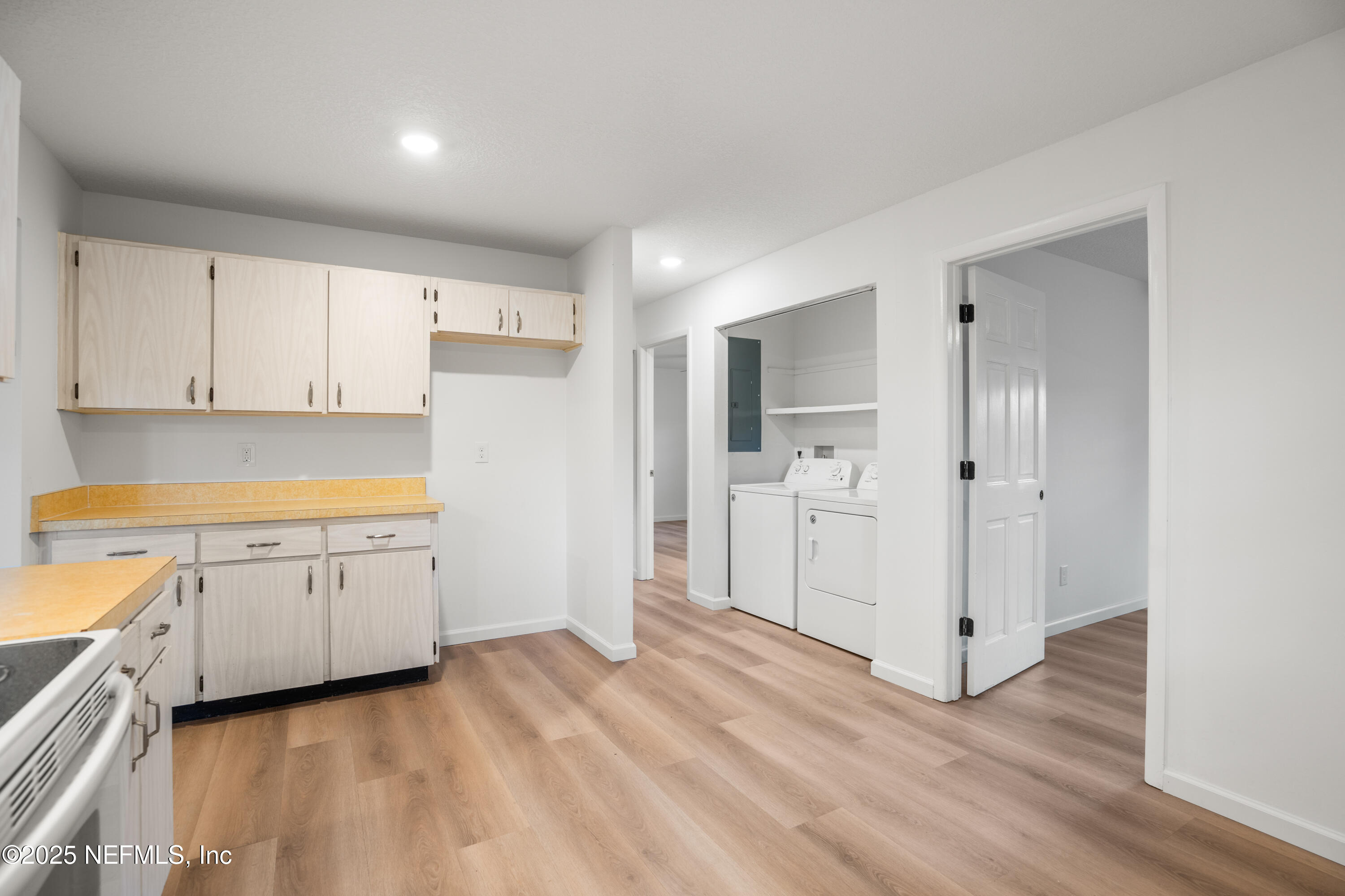 237 Marius Court St. Augustine, FL 32086 - Photo 11 of 45 a view of a kitchen with white cabinets and wooden floor