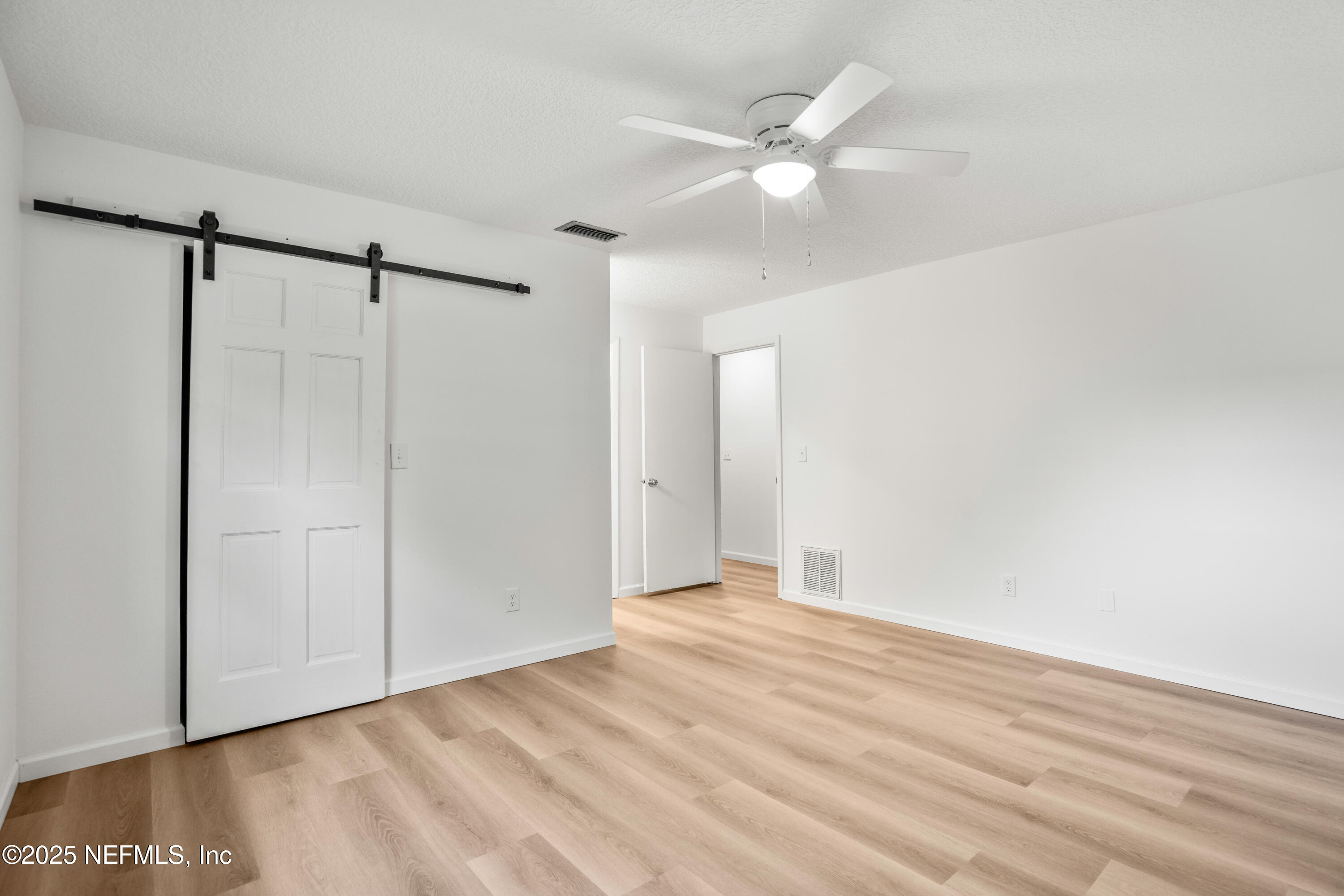 237 Marius Court St. Augustine, FL 32086 - Photo 13 of 45 a view of an empty room with wooden floor and a ceiling fan
