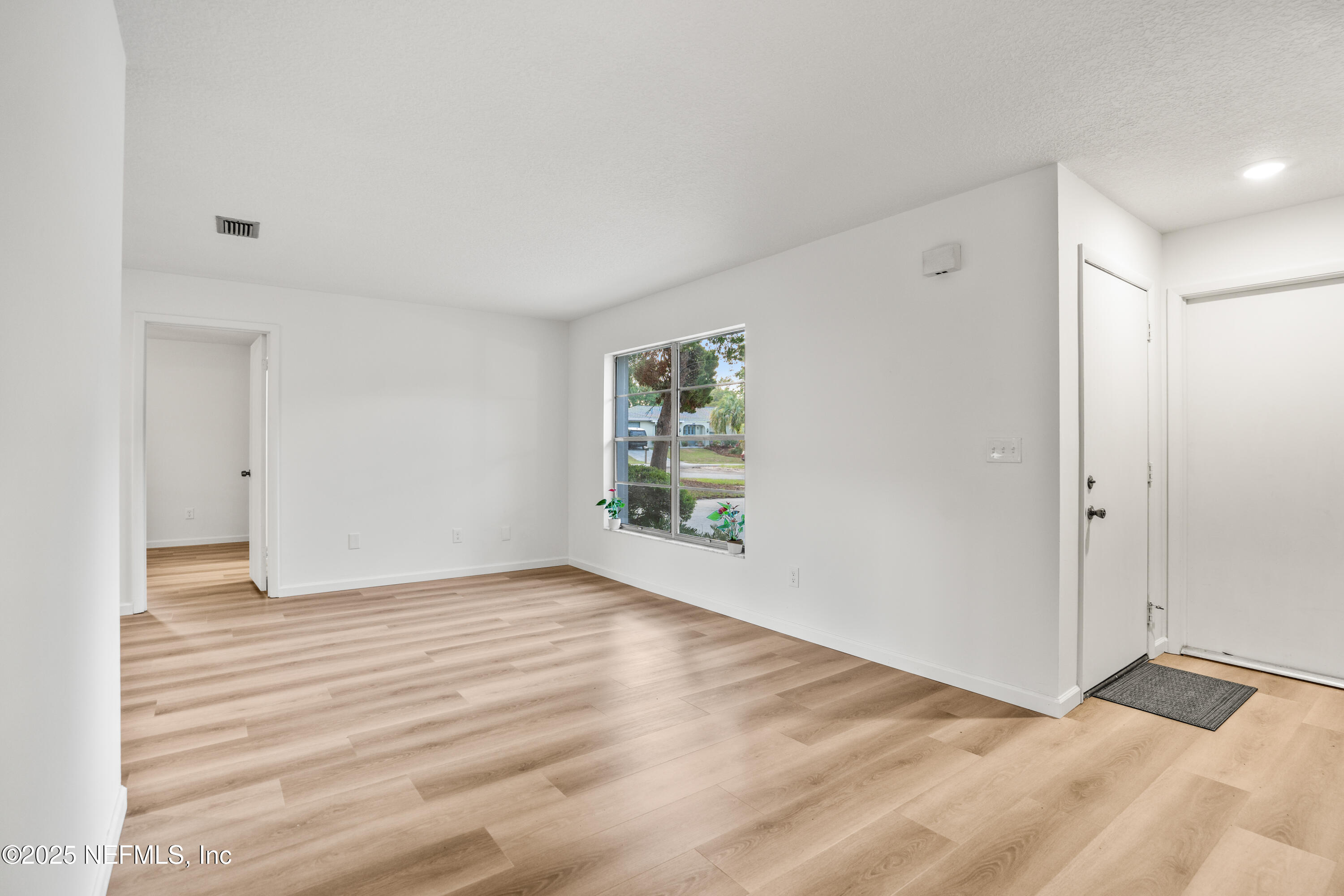 237 Marius Court St. Augustine, FL 32086 - Photo 4 of 45 a view of an empty room with wooden floor and a window