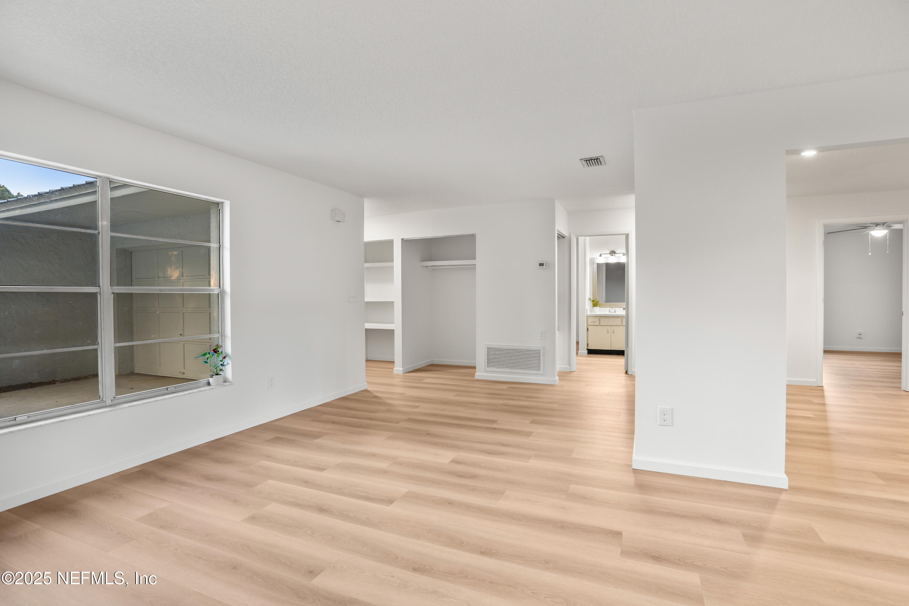 237 Marius Court St. Augustine, FL 32086 - Photo 5 of 45 a view of an empty room with wooden floor and a window