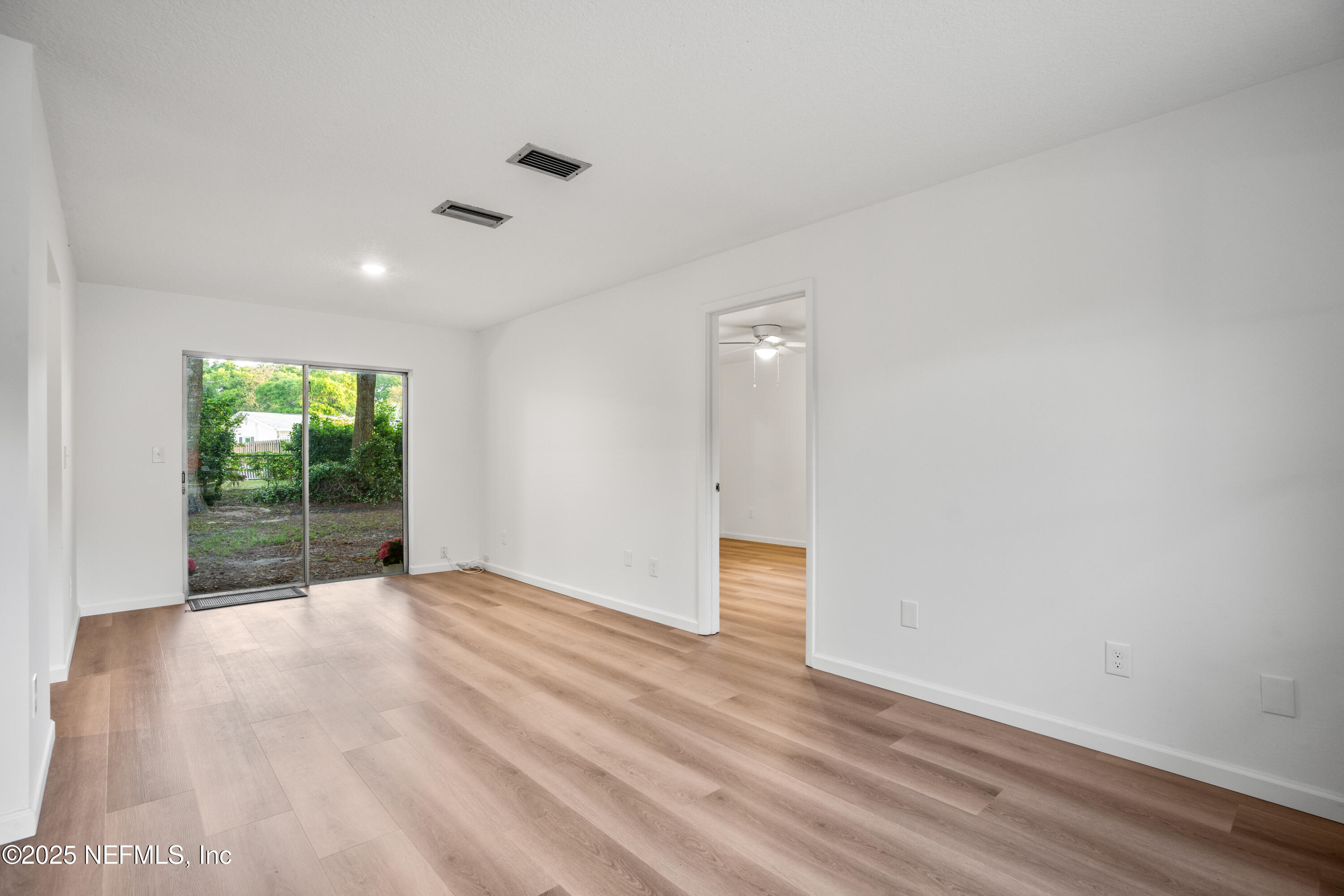 237 Marius Court St. Augustine, FL 32086 - Photo 7 of 45 a view of an empty room with wooden floor and a window