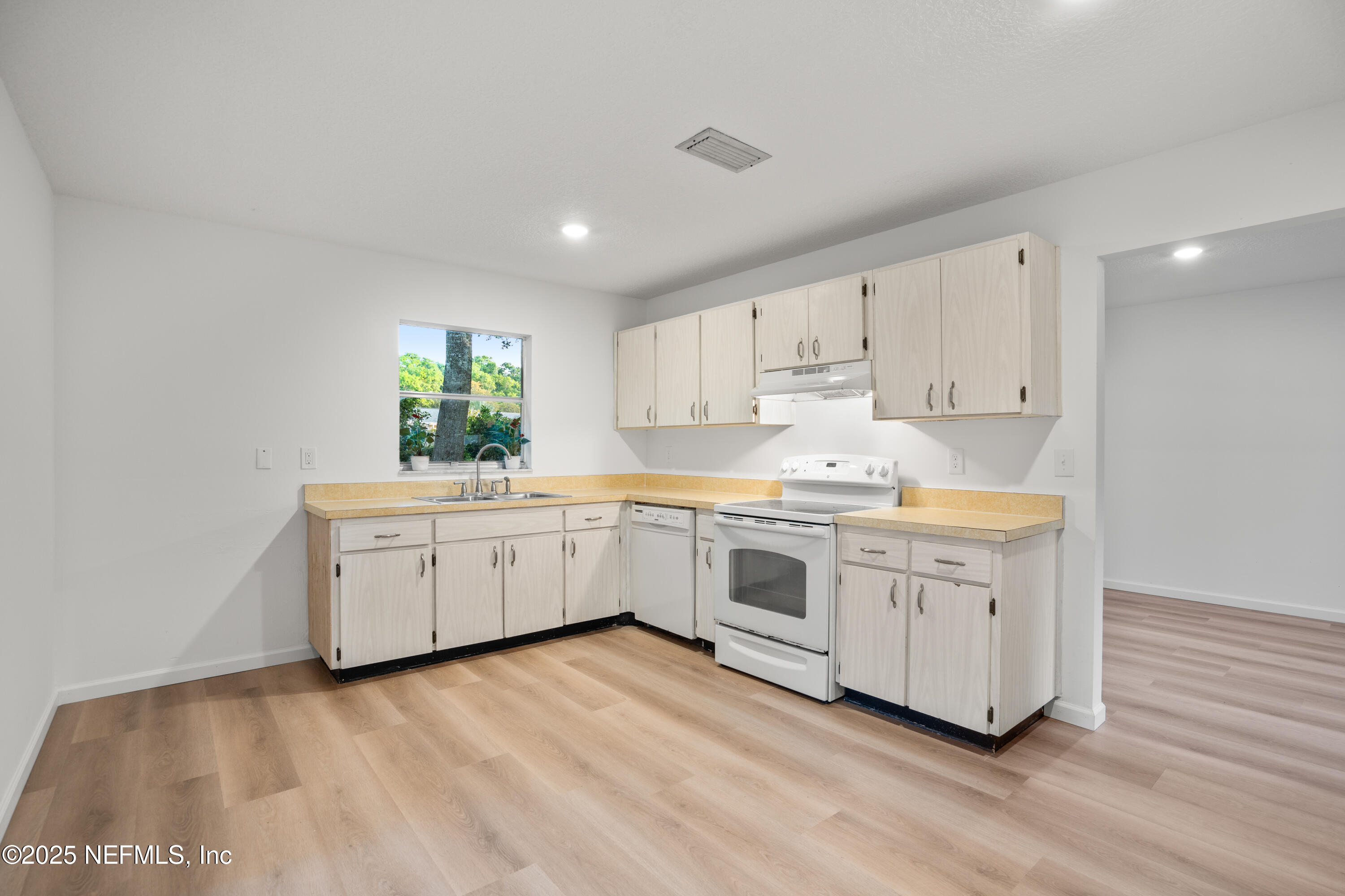 237 Marius Court St. Augustine, FL 32086 - Photo 9 of 45 a kitchen with white cabinets white stainless steel appliances and sink