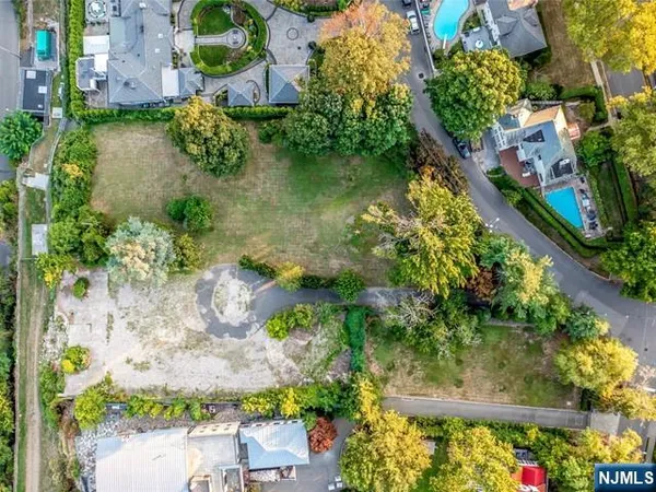 an aerial view of a house with a yard and garden